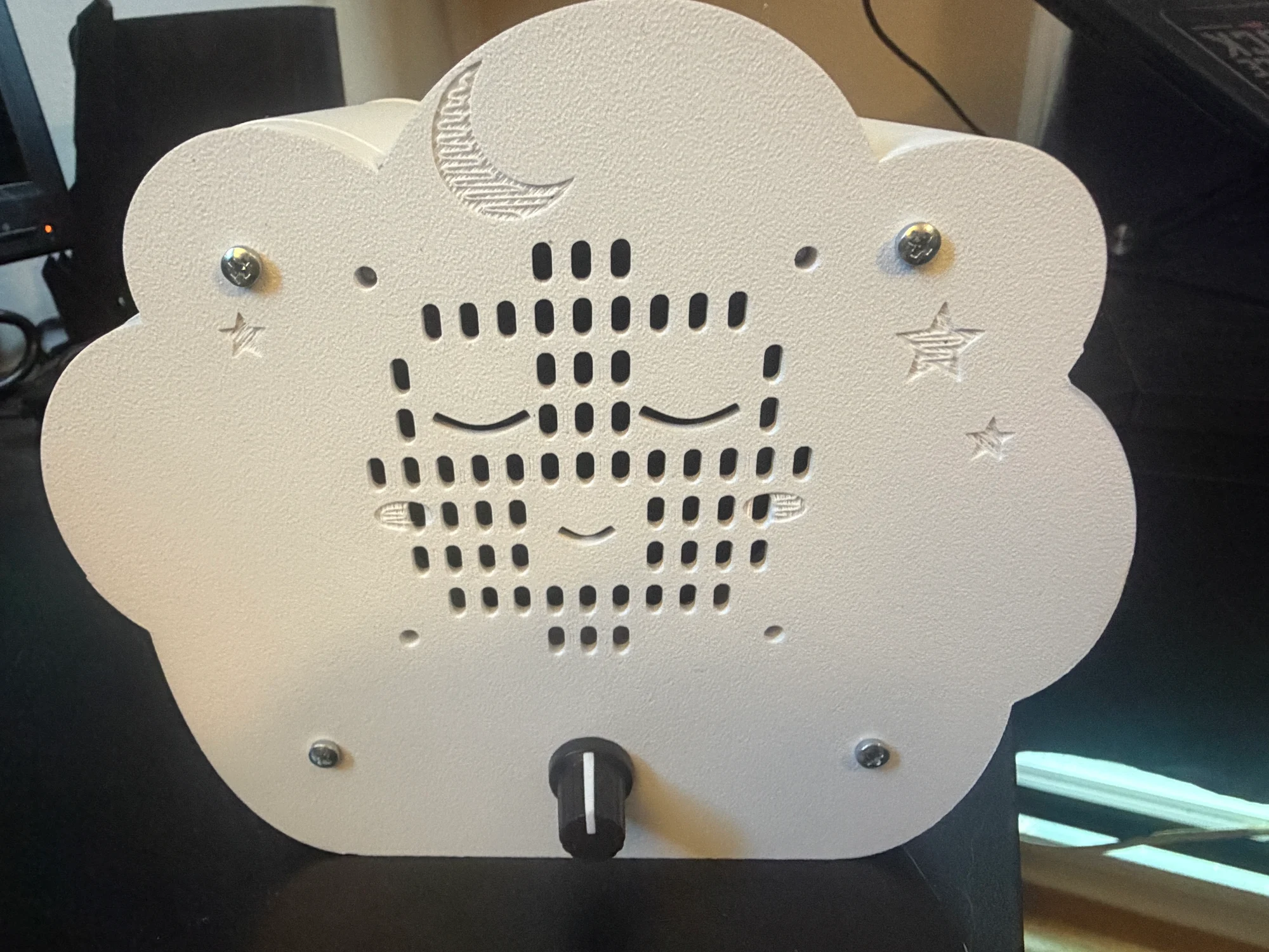 The front of the working cloud, with sleepy eyes, moon, stars, and a volume knob.