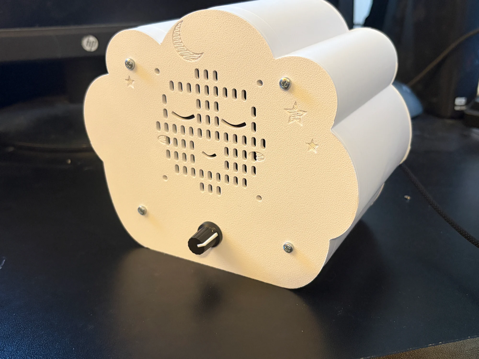 The assembled Sleepy Cloud noise machine, with its speaker grille and volume knob.